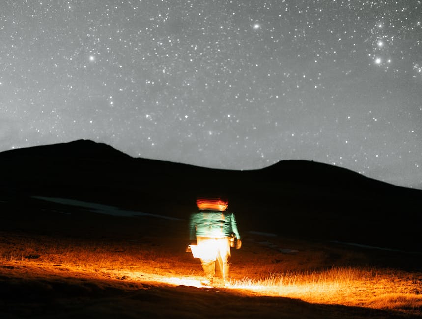 A lone hiker under a starry sky in Ordesa Valley, Aragon, creating a magical nighttime scene.