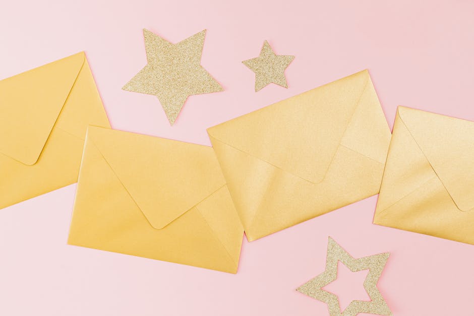 Golden envelopes and glittery stars on a pink background, perfect for festive celebrations.
