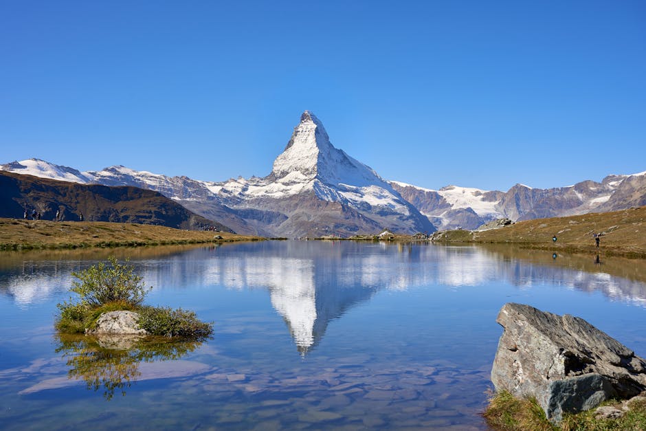 Breathtaking view of the Matterhorn reflected in a clear alpine lake in Zermatt, Switzerland.